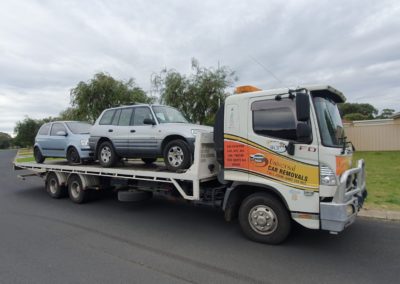 Tow truck towing two cars. Perth Towing and Tow Truck Services