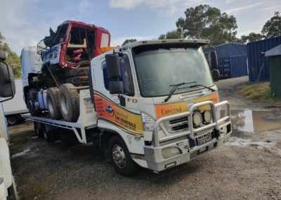 Tow truck towing a tractor. Perth Towing and Tow Truck Services