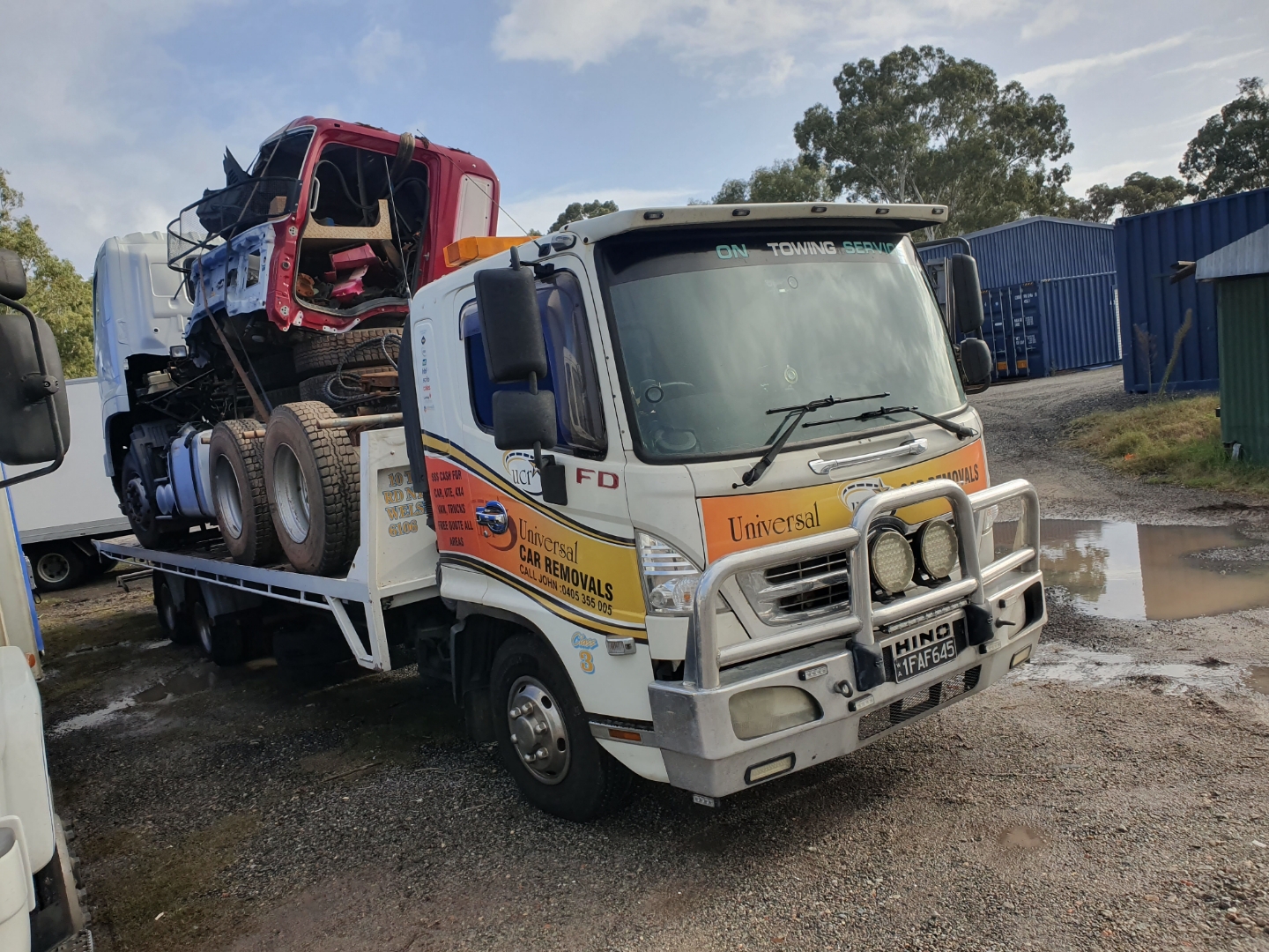 Tow truck towing a tractor. Perth Towing and Tow Truck Services